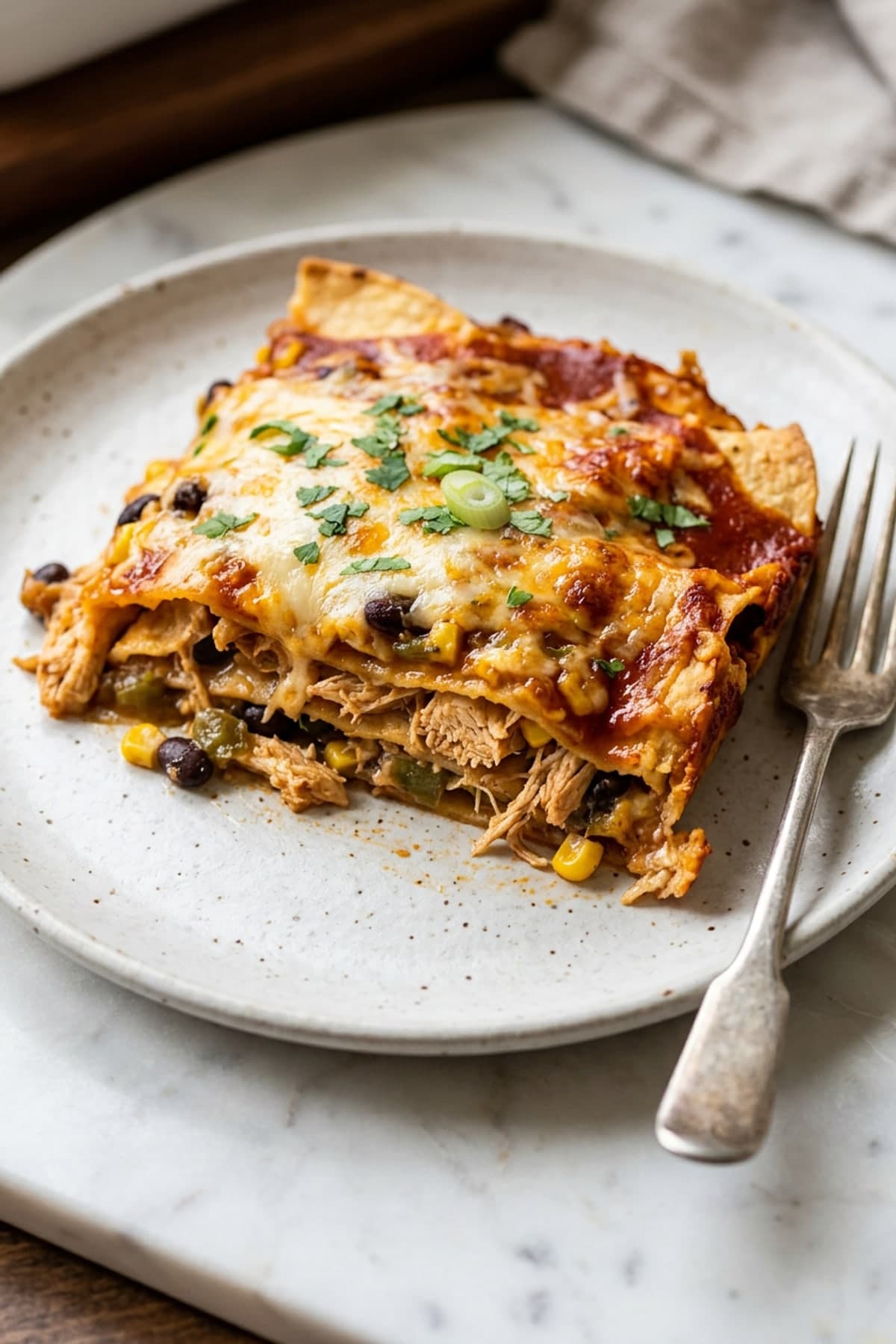 Layered Chicken Enchilada Casserole ready to serve